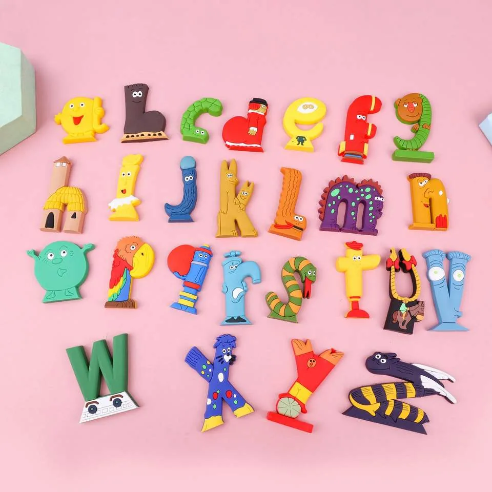 Juego completo de letras de PVC con alfabeto animal extendido sobre un fondo rosa con letras de personajes de la A a la Z
