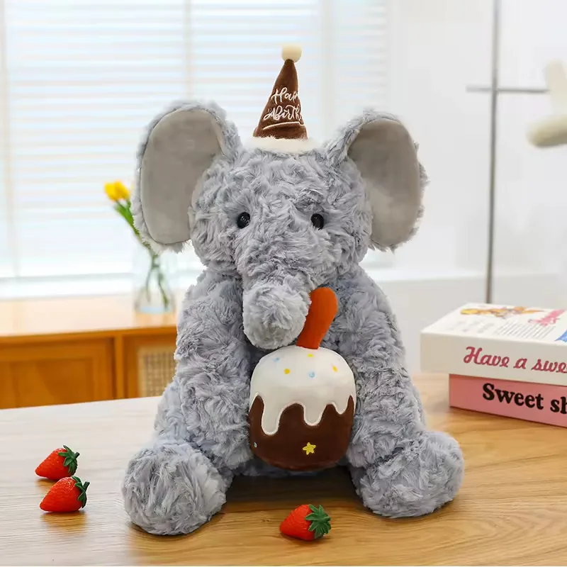 Elefante de peluche de cumpleaños gris con orejas grandes y accesorio de pastel con glaseado blanco