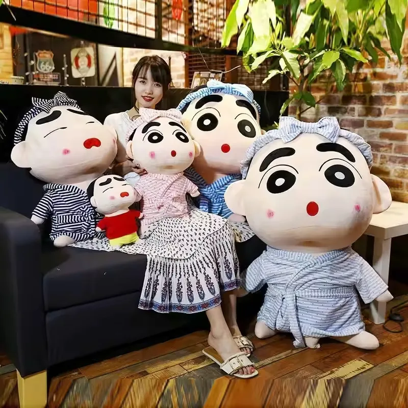 Crayon Shin-chan pajama plush dolls shown as a multi-size family with oversized character heads and blue sleepwear styling