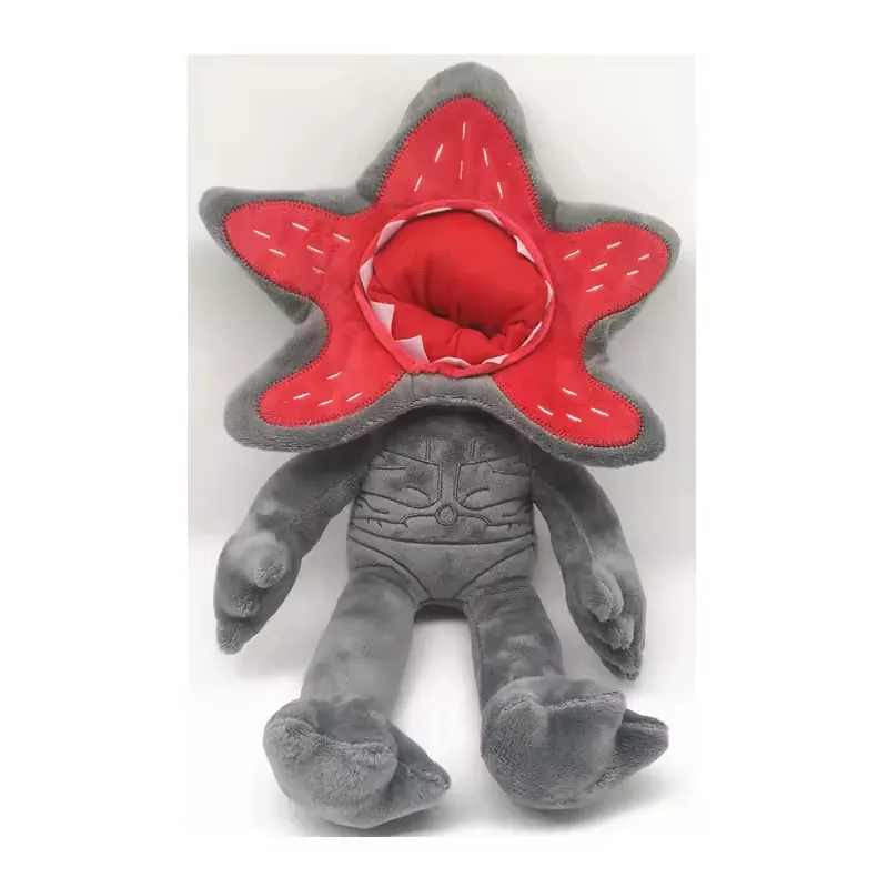 Muñeco de peluche Demogorgon gris con cuerpo sentado, detalle cosido en el torso y cara abierta roja con forma de pétalo
