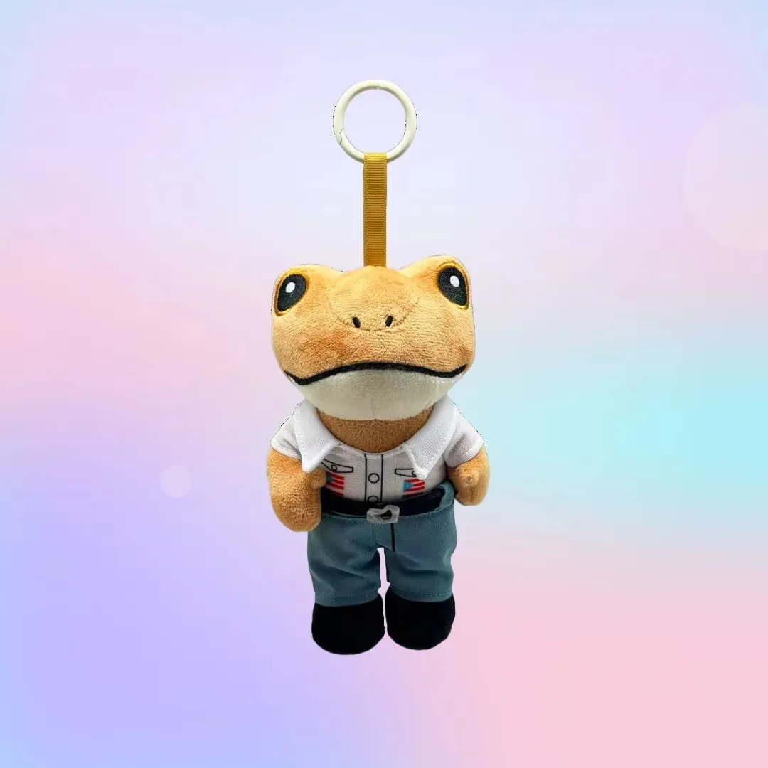 Llavero de rana de peluche con camiseta blanca, pantalones azules y zapatos negros