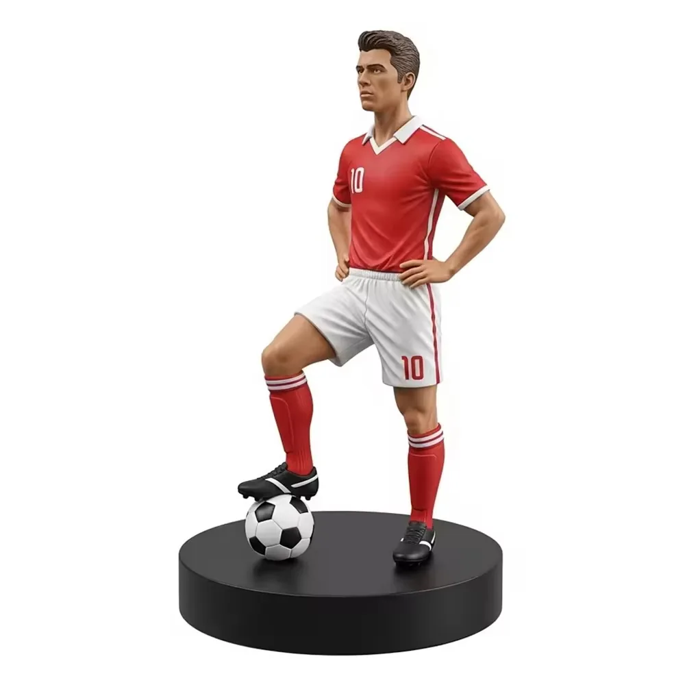 Hand-painted resin football star commemorative sculpture in a red number 10 kit with one foot on a football