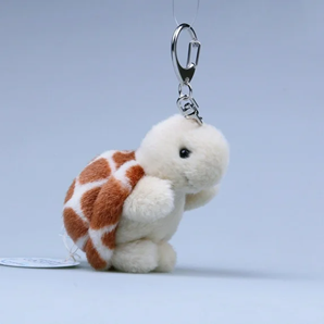 Mini turtle plush keychain hanging from a metal clasp