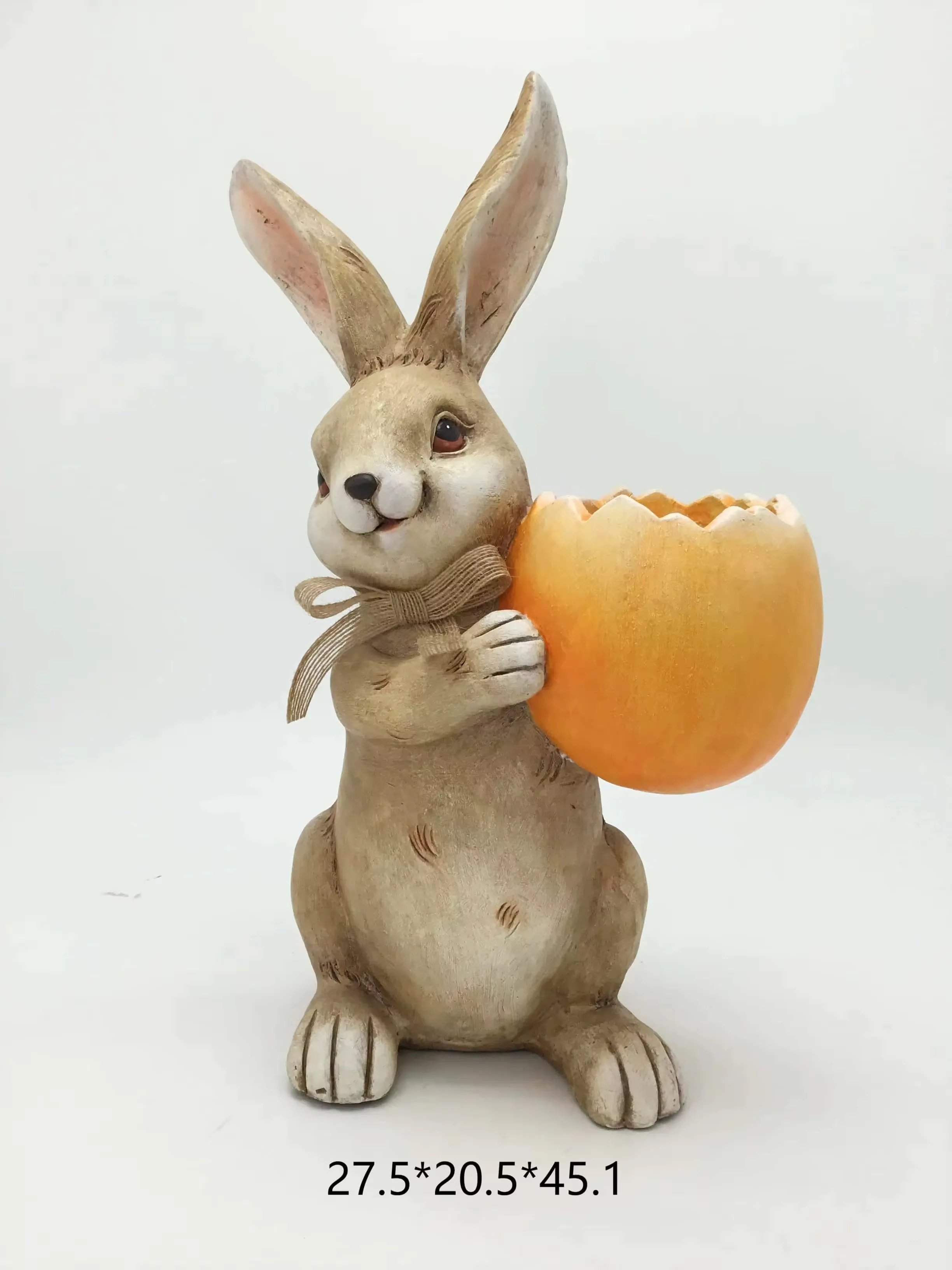 Realistic hand-painted resin rabbit figurine holding an orange cracked eggshell planter for Easter garden decor